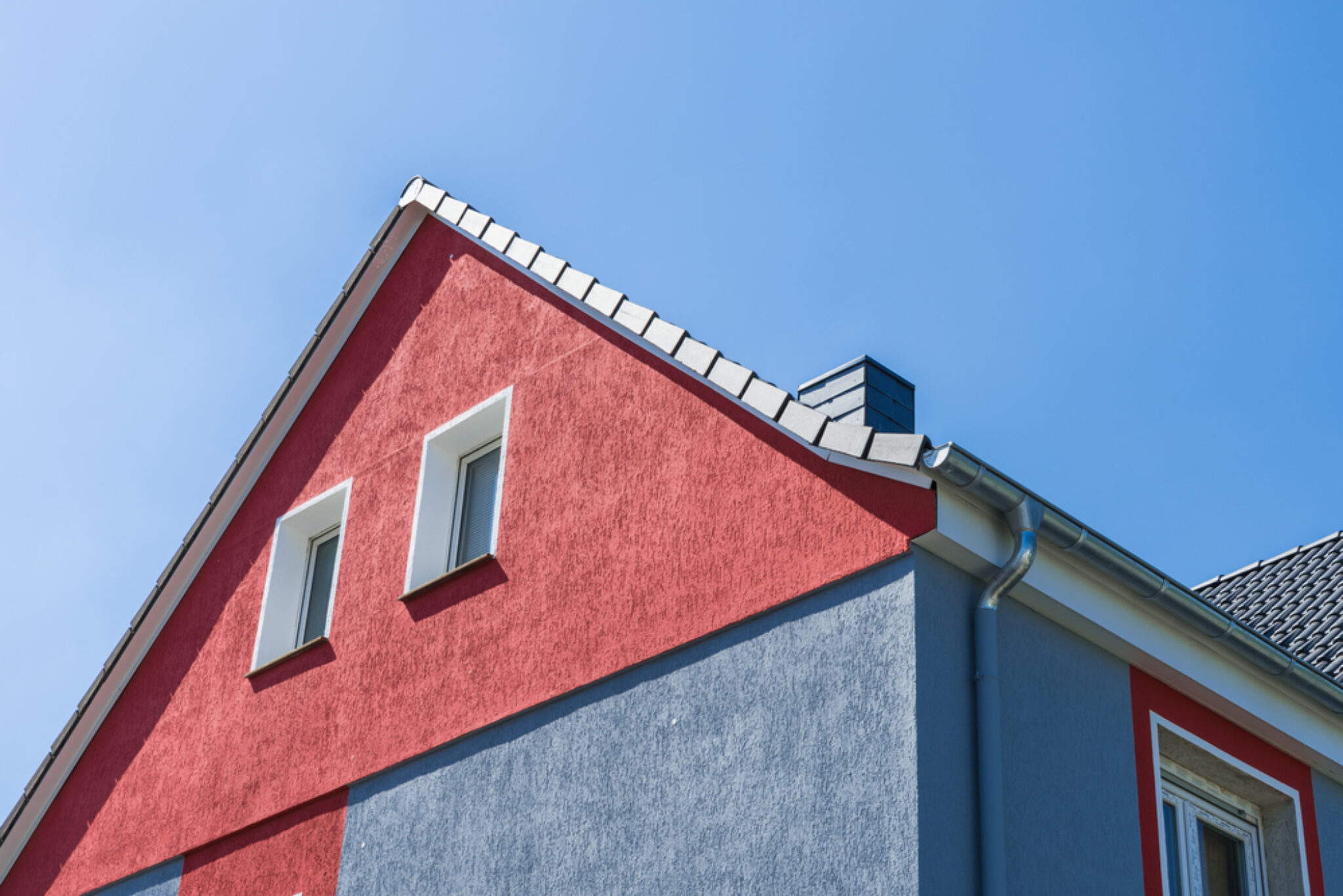 Renovated,Facade,With,Red,And,Gray,Rough,Plaster
